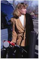Lady pumping gas